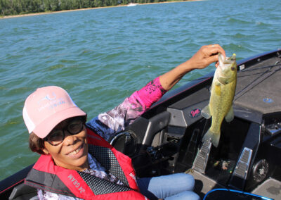 Pat Davis holds a nice bass she landed near the breakwall at East Harbor.